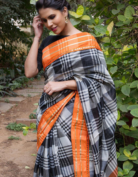 Black and white checked Linen Printed saree with orange mirror work border